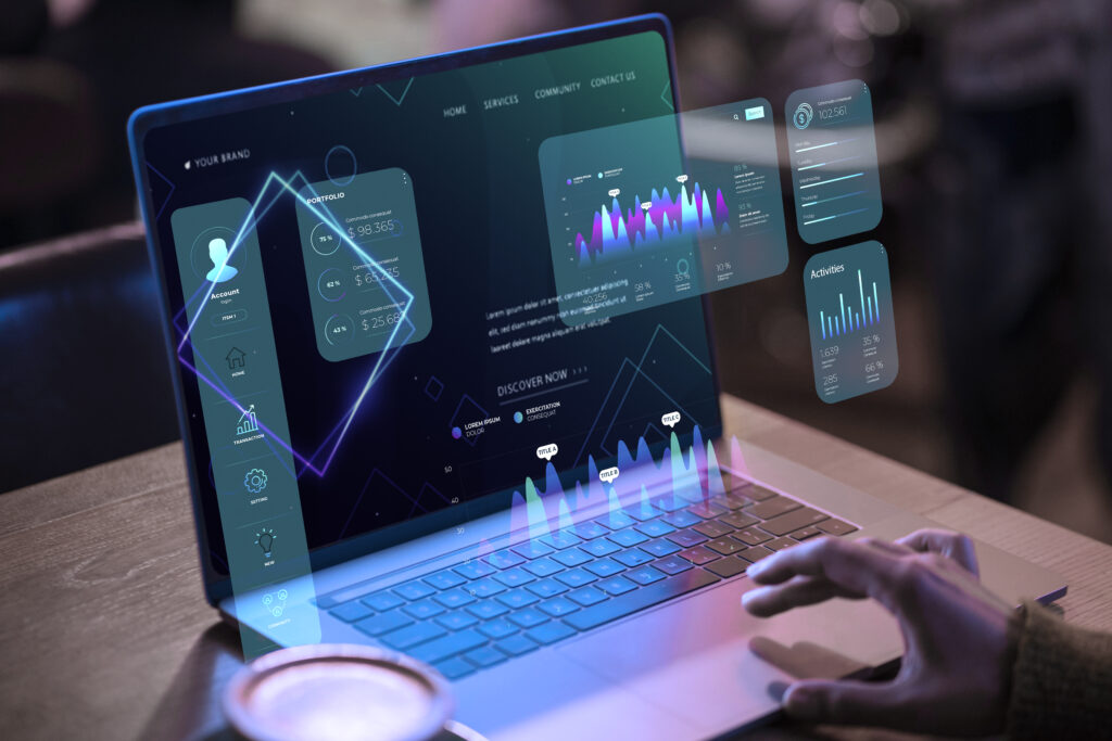 A person using a laptop with futuristic holographic financial dashboards and data visualizations displayed above the screen, showcasing analytics and portfolio metrics