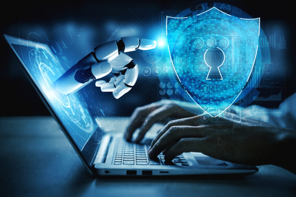 AI-powered cybersecurity concept showing robotic hand emerging from laptop screen toward a digital shield with a keyhole, symbolizing data protection and enterprise security.
