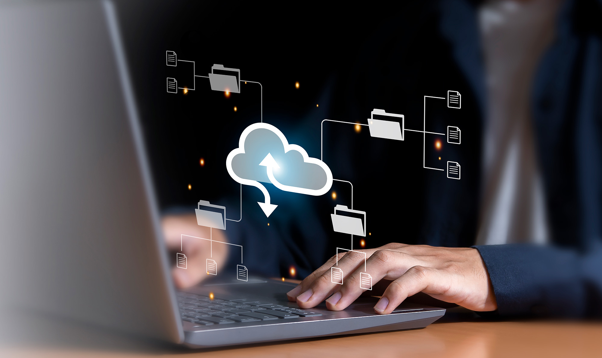 Person using a laptop with cloud migration icons showing files and folders moving to the cloud, symbolizing cloud migration consulting.