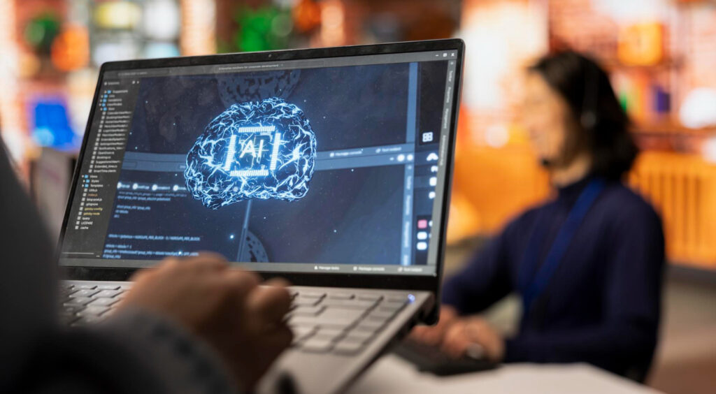 A person using a laptop displaying a digital illustration of an AI brain with code and neural graphics on the screen, symbolizing artificial intelligence development and data training.