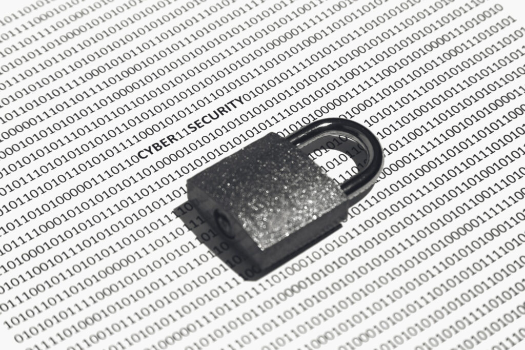 Padlock placed on binary code illustrating cybersecurity, data privacy, and protection of digital systems.