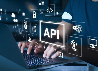 API Development Integration Hands typing on a laptop with digital icons representing API integration, cloud computing, security, and data exchange.